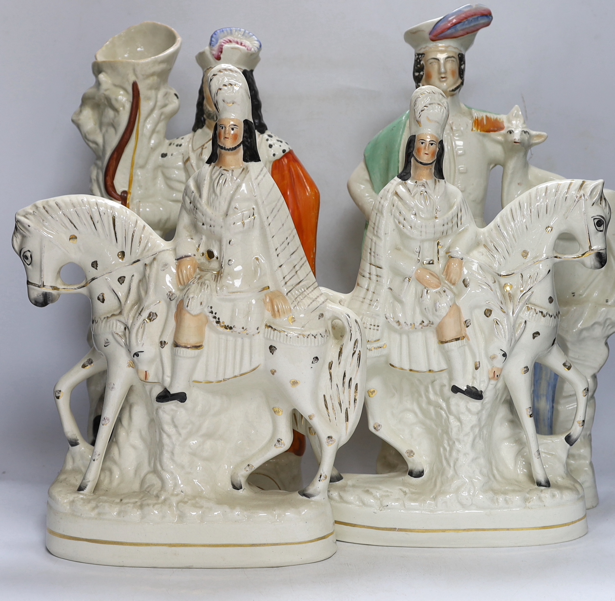 A pair of large mid 19th century Staffordshire pottery highland hunters, on horseback and three other Staffordshire pottery groups, largest 44 cm high (5)
